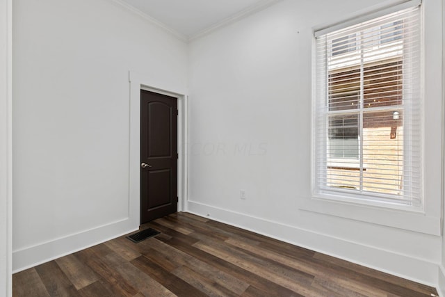 spare room featuring dark hardwood / wood-style floors and ornamental molding