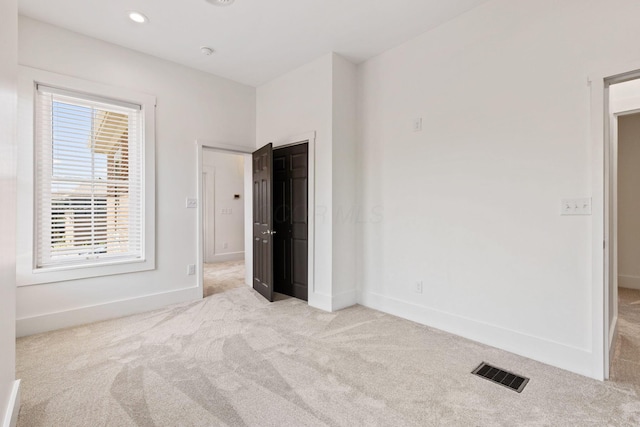 unfurnished bedroom with light carpet