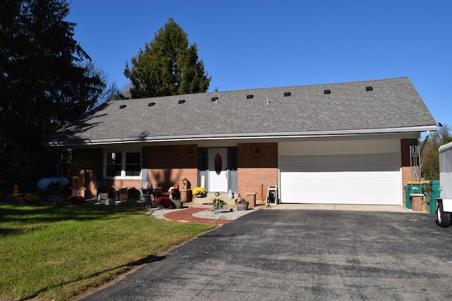 single story home with a front yard and a garage