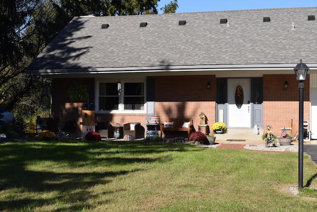 rear view of house with a lawn