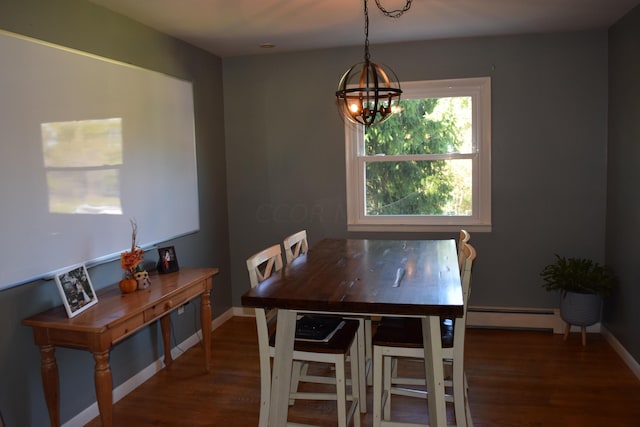 dining room with a notable chandelier, dark wood-type flooring, and a baseboard heating unit