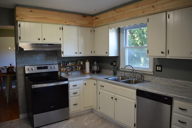 kitchen with white cabinets, sink, stainless steel appliances, and tasteful backsplash