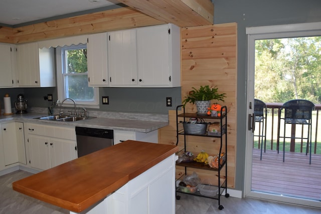 kitchen featuring kitchen peninsula, white cabinetry, dishwasher, and sink