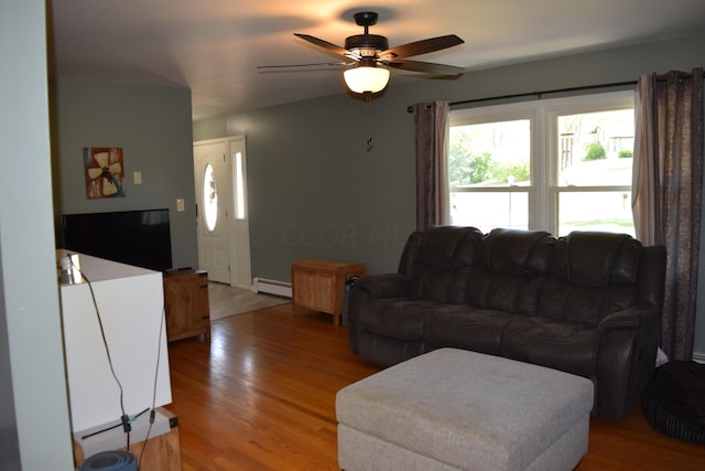 living room with light wood-type flooring, a baseboard radiator, and ceiling fan