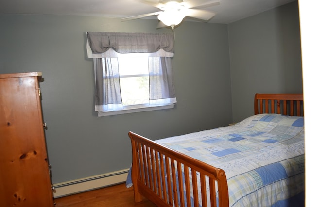 bedroom featuring ceiling fan, wood-type flooring, and baseboard heating