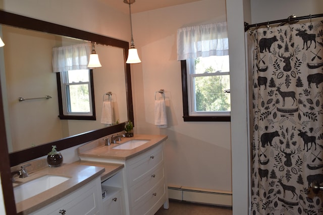 bathroom featuring curtained shower, vanity, and a baseboard radiator