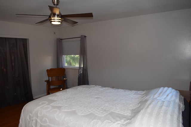 bedroom featuring a closet, ceiling fan, and dark wood-type flooring