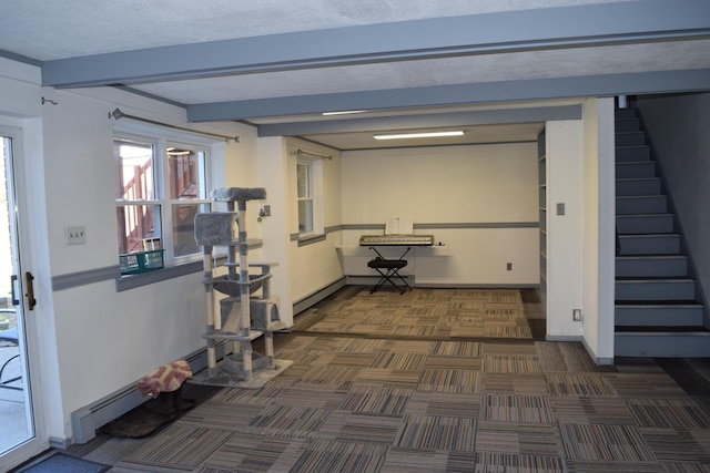 corridor featuring dark colored carpet, beam ceiling, and a textured ceiling