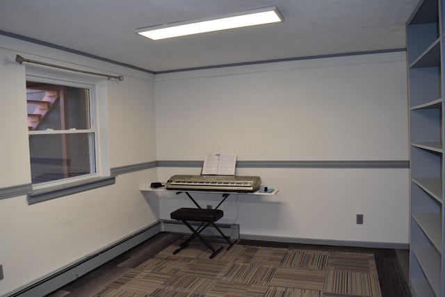 office area with a baseboard heating unit