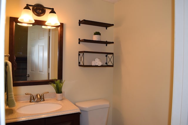 bathroom featuring toilet and vanity