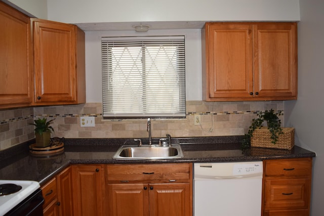 kitchen with white dishwasher, tasteful backsplash, and sink