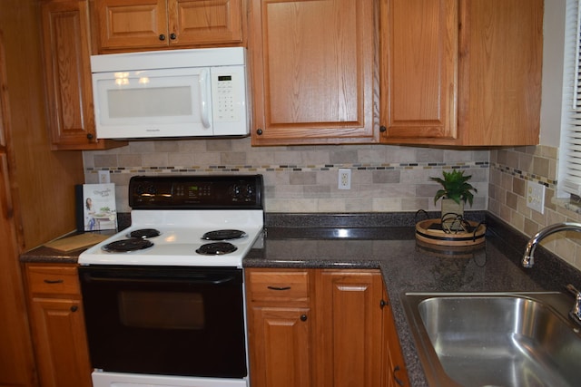 kitchen featuring sink, backsplash, and electric range oven