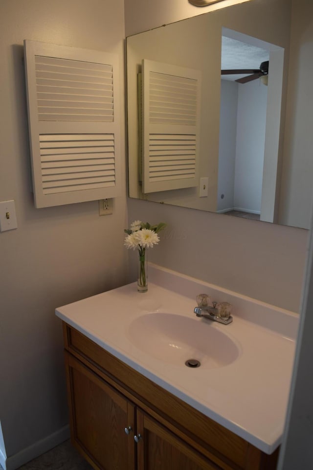 bathroom featuring ceiling fan and vanity