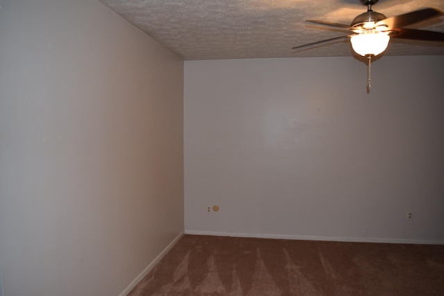 carpeted spare room with ceiling fan and a textured ceiling