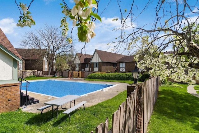 view of pool with a lawn