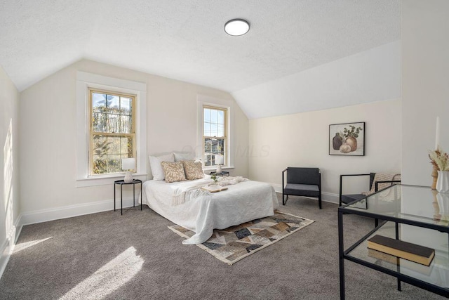 carpeted bedroom featuring a textured ceiling and lofted ceiling