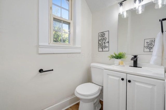 bathroom with vanity, a textured ceiling, and toilet