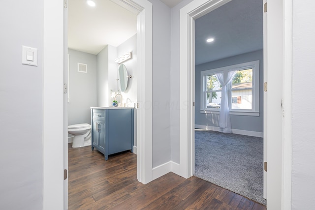 bathroom featuring hardwood / wood-style floors, vanity, and toilet