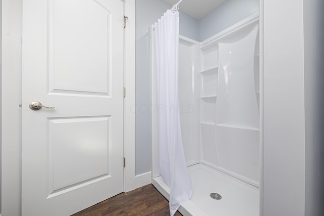 bathroom with a shower with curtain and hardwood / wood-style flooring