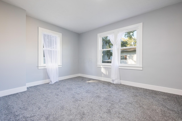 unfurnished room featuring carpet flooring