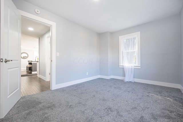 empty room with dark carpet