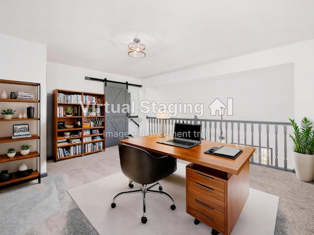 carpeted office space with a barn door