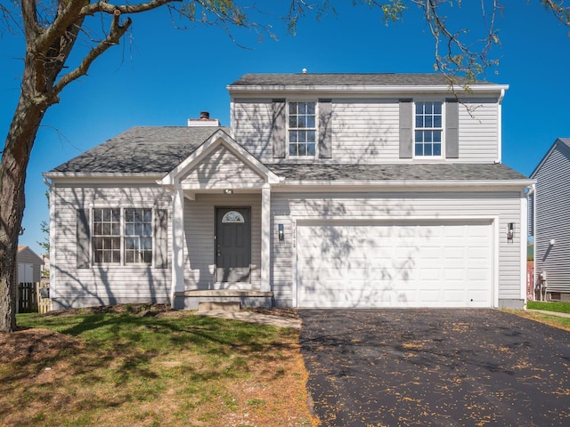 front of property with a front lawn and a garage