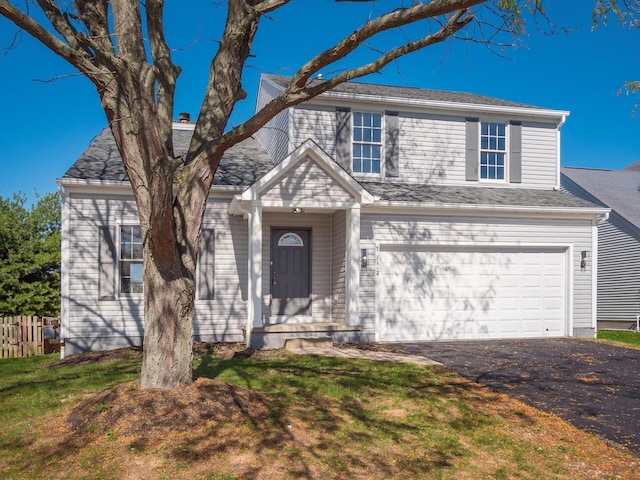 view of front of house with a garage and a front lawn