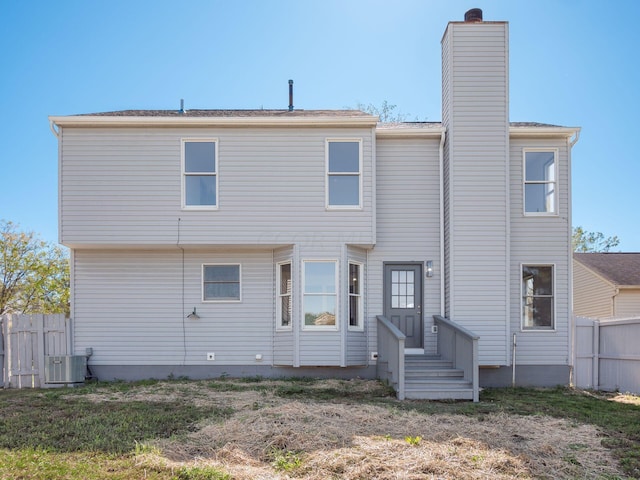 back of house with central AC unit