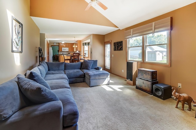 carpeted living room featuring ceiling fan and lofted ceiling