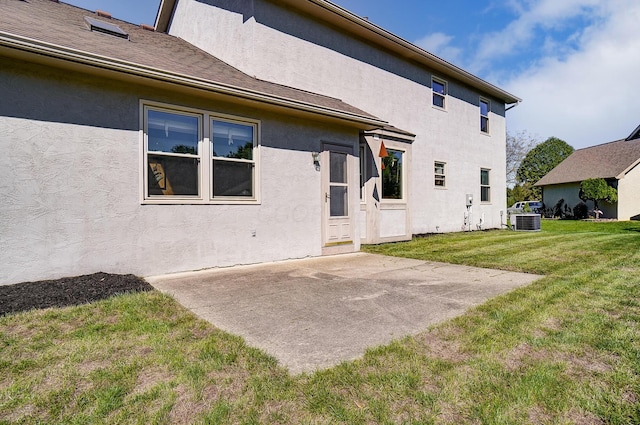 rear view of house featuring a patio, central AC unit, and a lawn