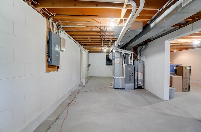 basement featuring gas water heater, electric panel, and heating unit