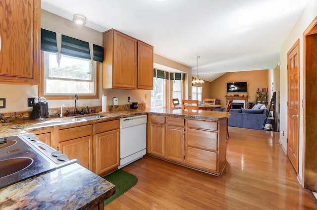 kitchen featuring kitchen peninsula, white dishwasher, sink, light hardwood / wood-style flooring, and lofted ceiling