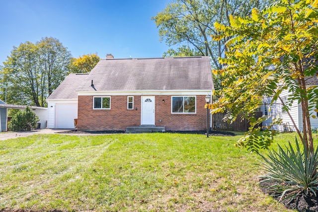 view of front of property with a garage and a front lawn