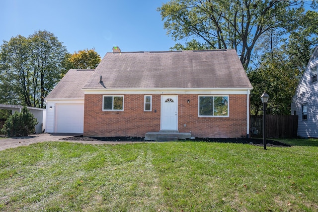 view of front of property featuring a front yard and a garage