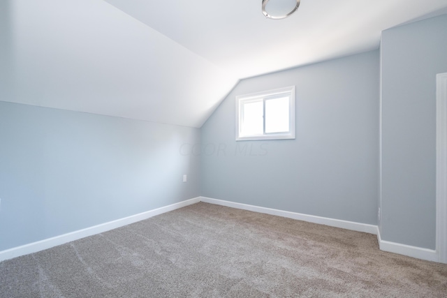 bonus room featuring carpet flooring and vaulted ceiling