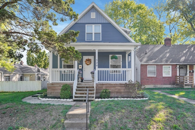 bungalow-style home with a porch and a front lawn