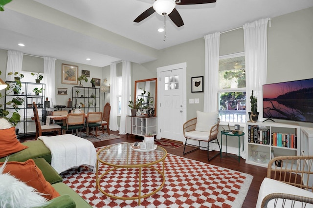 living room featuring ceiling fan and dark hardwood / wood-style floors