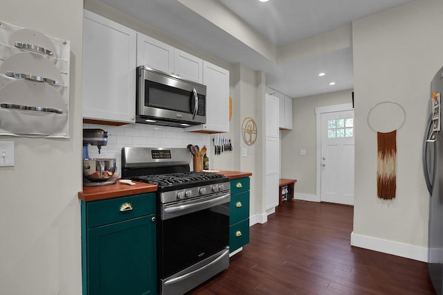 kitchen featuring wood counters, backsplash, stainless steel appliances, dark wood-type flooring, and white cabinetry