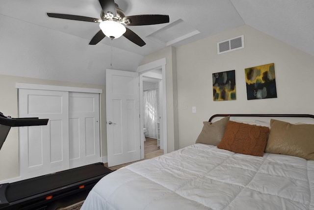 bedroom with ceiling fan, a closet, light hardwood / wood-style floors, and vaulted ceiling