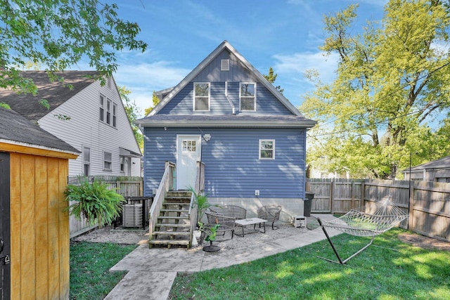 back of property with a patio area and a lawn