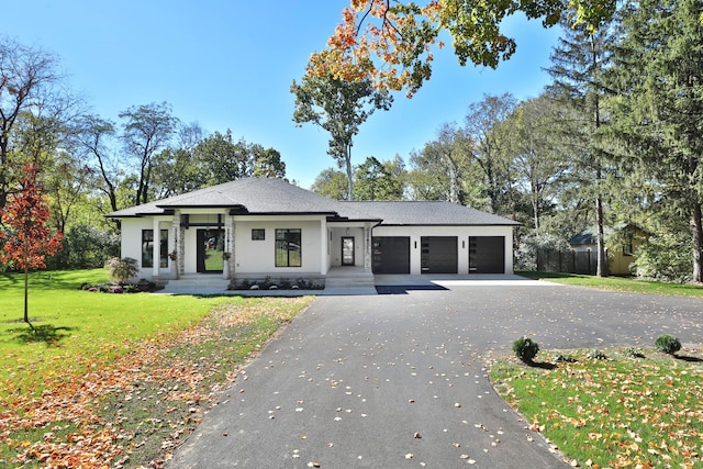 prairie-style house featuring a front yard and a garage