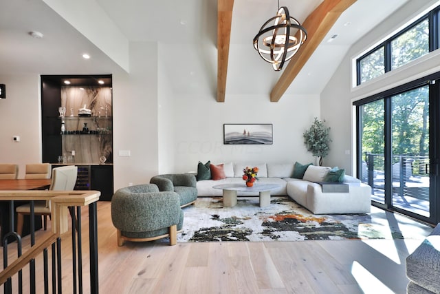 living room with hardwood / wood-style flooring, beamed ceiling, high vaulted ceiling, and a chandelier