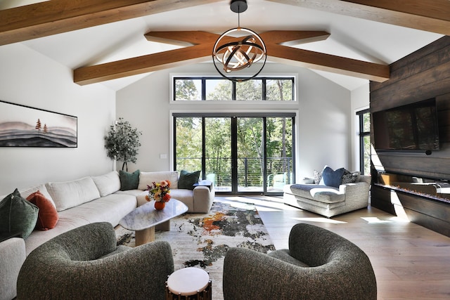 living room featuring hardwood / wood-style floors, beam ceiling, and high vaulted ceiling