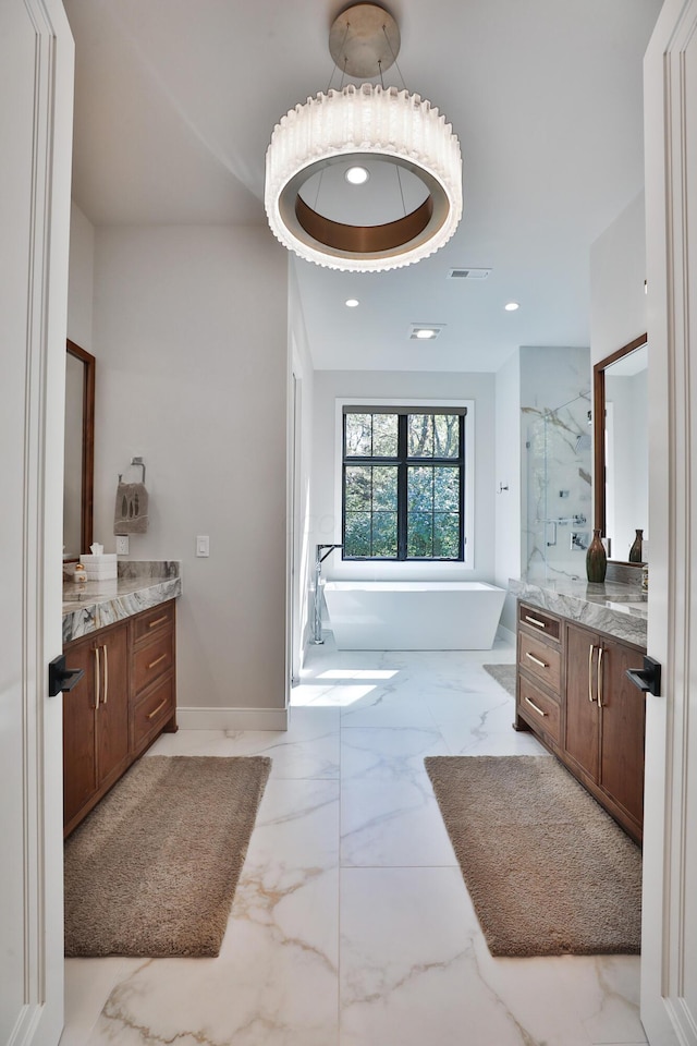 bathroom featuring shower with separate bathtub and vanity