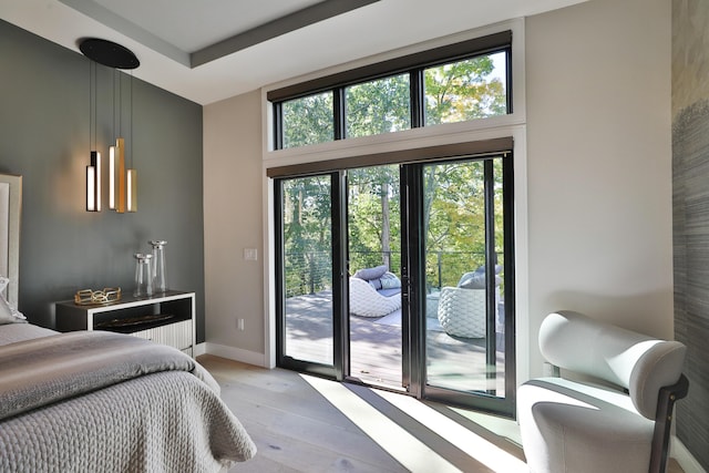 bedroom featuring access to outside and light hardwood / wood-style flooring