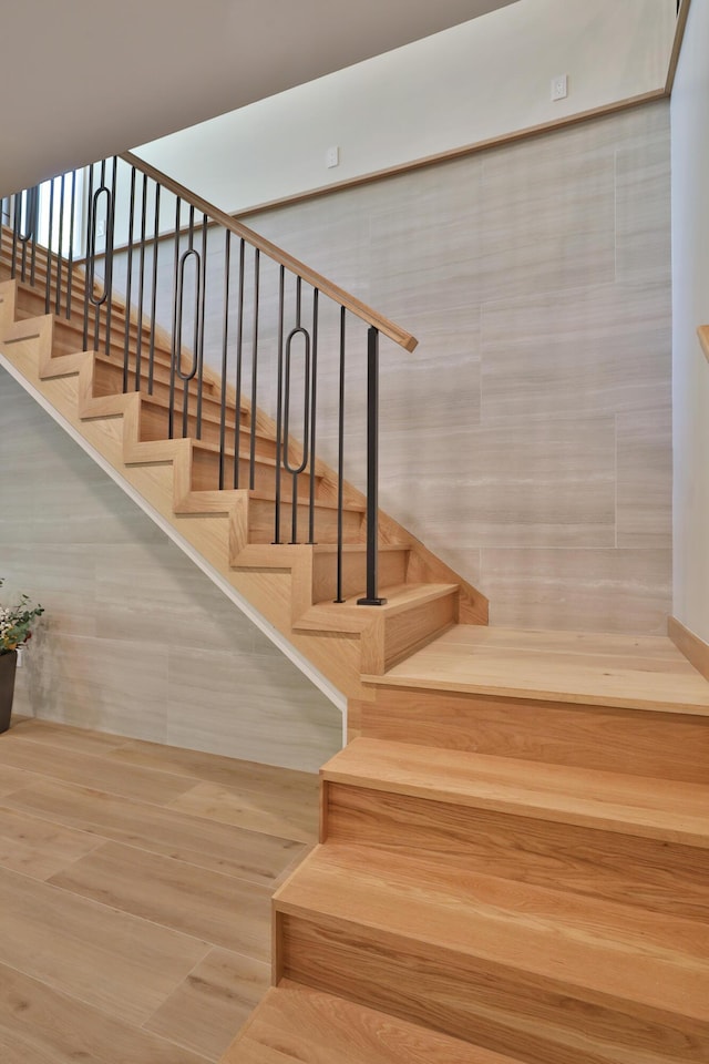 staircase with tile walls