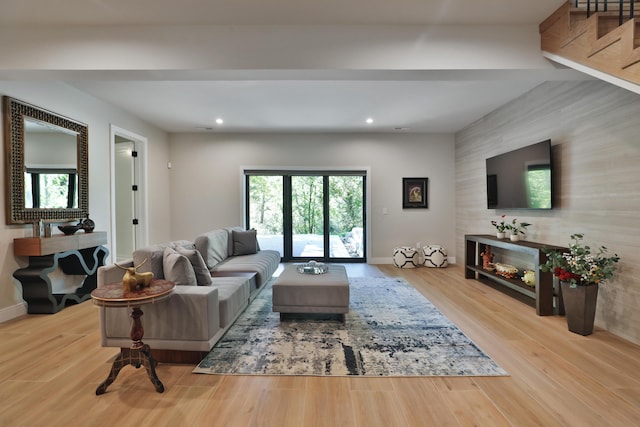 living room featuring wood-type flooring and a fireplace