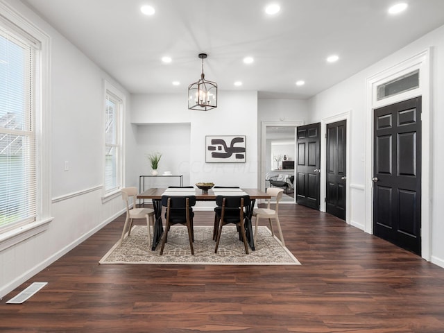 dining area with a chandelier, a healthy amount of sunlight, and dark hardwood / wood-style floors