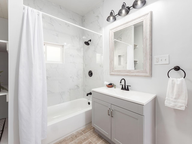 bathroom with hardwood / wood-style floors, vanity, and shower / bathtub combination with curtain